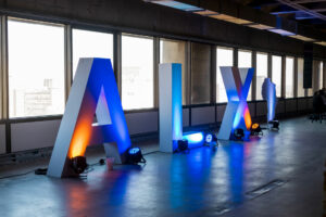 Large illuminated ALX letters in an office space