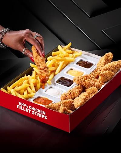 KFC Strips box with a hand dipping a chicken strip into a sauce, next to fries and five dips