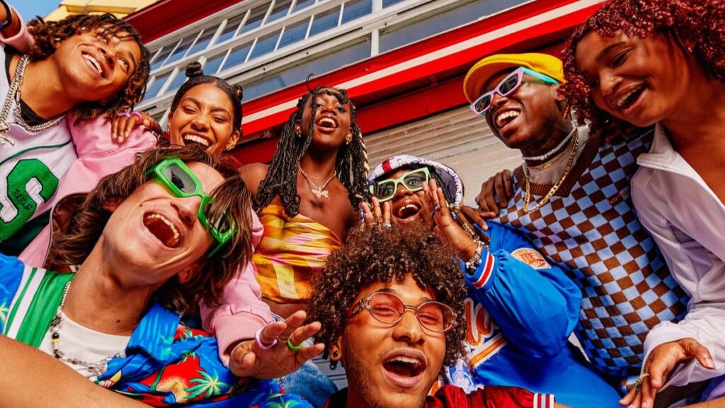 Marketing to Gen Z: a group of laughing friends in colourful clothes posing together for a group selfie